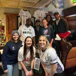 Board members of DC Spurs with representatives of DC SCORES at our annual holiday fundraiser in December 2023.